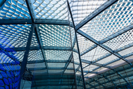 The geometry of modern urban architecture is reflected in the glass facades of buildingsの写真素材