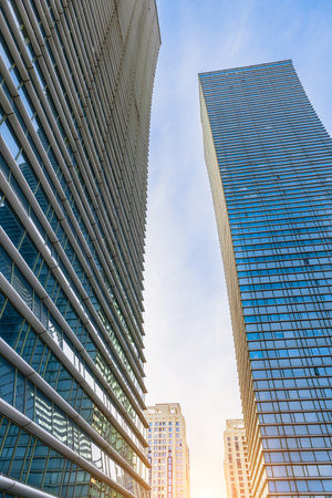 Sunset reflected off modern glass facades of skyscrapers in the financial center of the cityの写真素材