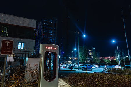 October 20, 2022 Astana, Kazakhstan: Empty Tesla electric car charging station against the backdrop of the city at nightのeditorial素材