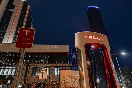 October 20, 2022 Astana, Kazakhstan: Empty Tesla electric car charging station against the backdrop of the city at nightのeditorial素材