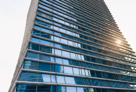 Sunset reflected off modern glass facades of skyscrapers in the financial center of the cityの写真素材