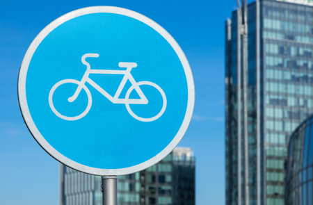 Bicycle sign in the city on the background of buildingsの写真素材