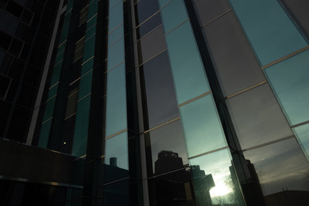 The geometry of modern urban architecture is reflected in the glass facades of buildings