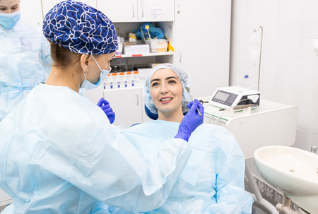 Dentistry concept. Professional dental services and modern equipment without pain. Doctor with an assistant treating the patients teethの写真素材