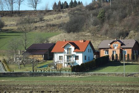 Jaslo, Poland - 9 2 2019: The project of a modern villa. Project of a small villa with clear walls and a brown roof. Rear and front courtyard of a private territory. Mastering new land and building.のeditorial素材