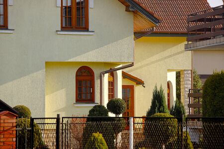 Jaslo, Poland - 9 2 2019: The project of a modern villa. Project of a small villa with clear walls and a brown roof. Rear and front courtyard of a private territory. Mastering new land and building.のeditorial素材