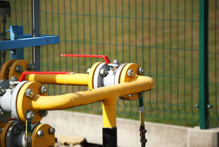 Element gas line high and medium pressure. Yellow transport pipes on the surface of the fence....