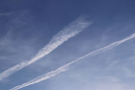 Blue sky with white cirrus clouds on a sunny clear day. Natural background for later design. Weather...