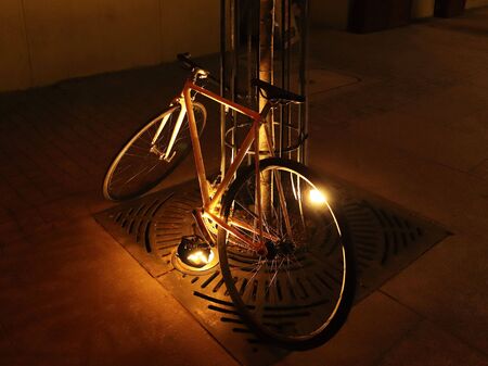 The bike stands leaning against a tree in the center of the ancient city in the evening. Ecology of...