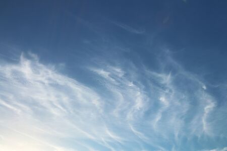 Cirrus clouds on a clear blue sky. Weather forecast. Water in a gaseous state in nature. The...
