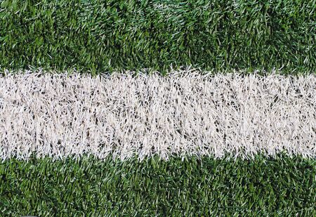 Marking a green artificial football field with a grass cover in the city stadium. The place for...