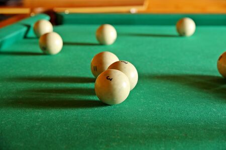Russian billiards. Numbered ivory balls lay on the green cloth of the bijar table. Gambling for money for adults. Rest after work in a tavern. Production of board games. International sports competiti.の写真素材