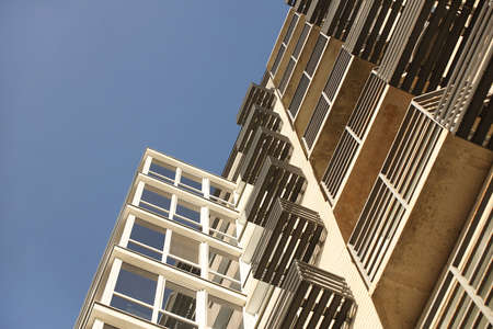 Lviv, Ukraine - 3 4 2020: Facade of a tall multi-storey modern house with balconies and large glass...