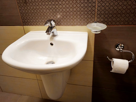 Bathroom faucet and washbasin in the bathroomの写真素材