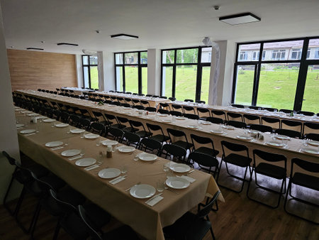 Served long table in a large dining room. Cutlery on the table. Wedding table without guests. Hall for ceremonial banquets on the occasion of important events for a large group of peopleの写真素材