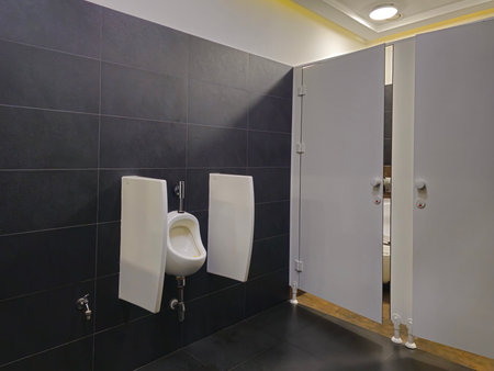 Interior of a bathroom with toilets. Design of sanitary facilities for personal care. Personal hygiene in public places. Ceramic products in everyday life.の写真素材