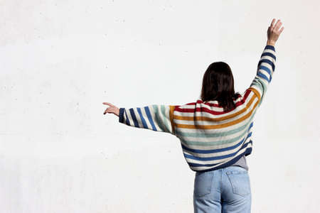 Girl in colored sweater on a white backgroundの写真素材