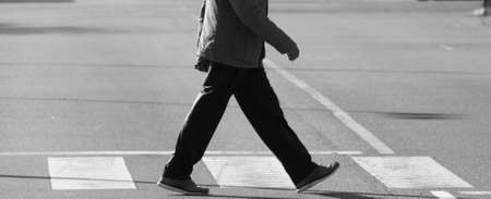 Man crossing a zebra crossing of the city