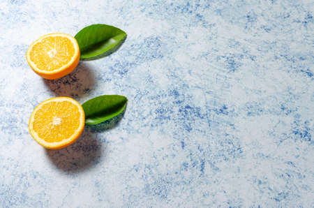 Oranges with their leaves on a blue backgroundの写真素材