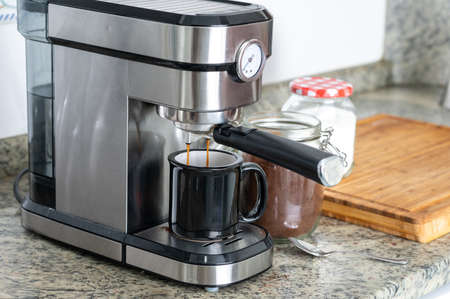 Making coffee at home with an espresso machineの写真素材