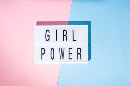 Girl power text on the lightbox. Top view of a concept of feminism with a pink and blue backgroundの写真素材