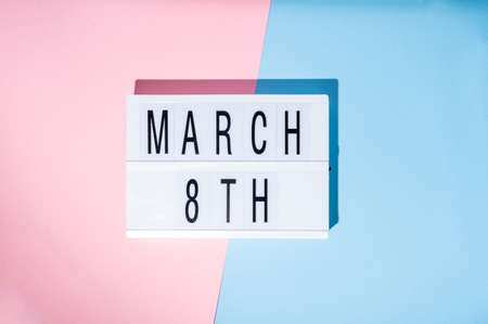 Womens Day, March 8th on the lightbox. Top view of a concept of feminism with a pink and blue backgroundの写真素材