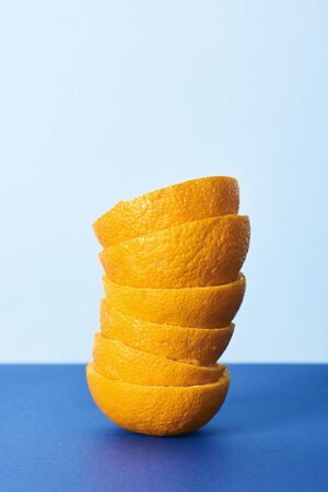 Orange juice and frosted orange on blue background