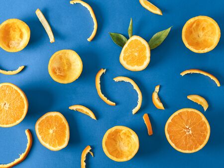 orange and orange peel on blue backgroundの写真素材