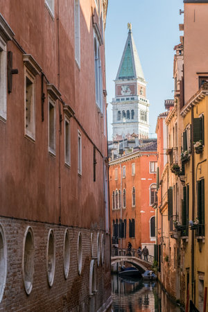 View of the Campanile tower through a street of Venice, Italyの写真素材