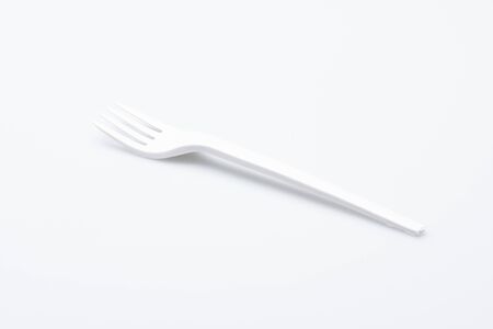 plastic fork isolated in front of a white backgroundの写真素材