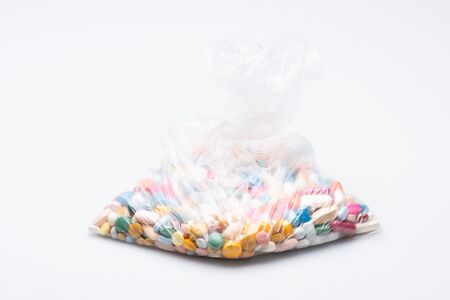 bag of pills isolated in front of a white background