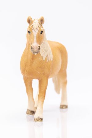 close up of a brown plastic horse isolated on a white backgroundの写真素材