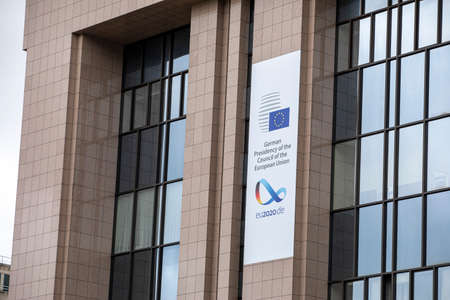 BRUSSELS, Belgium - July 1st, 2020: European flags blowing in front of the seat of the Council of...