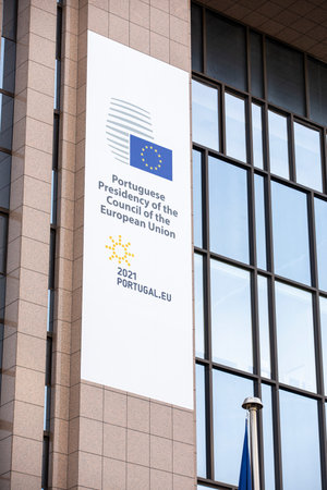 Brussels, Belgium - January 22, 2021: European flags fluttering in the wind in front of the European Council with the logo of the Portuguese rotating presidencyのeditorial素材