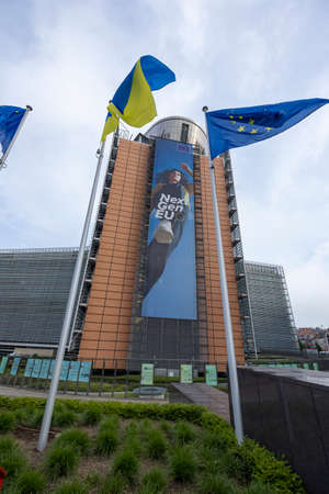 BRUSSELS, Belgium -May 7, 2022: Ukrainian and European flags blowing in front of the seat of the...