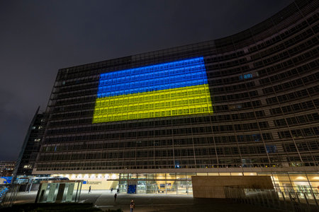 BRUSSELS, Belgium - February 23, 2023: Berlaymont building, seat of the European Commission, with the Ukrainian flag projected on the facade in solidarity with Ukraineのeditorial素材