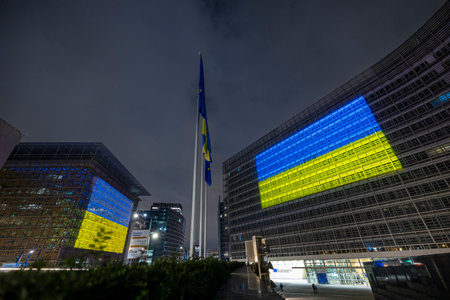 BRUSSELS, Belgium - February 23, 2023: seat of the European Council and European Commission with the Ukrainian flag projected on the facades in solidarity with Ukraineのeditorial素材