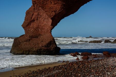 Details and landscapes of Legzira beach, with its bored rocks, on the Atlantic coast of southern Moroccoの写真素材