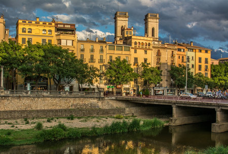 Sunset reflected in the houses of the old town of Girona, in the northeast of Cataloniaの写真素材