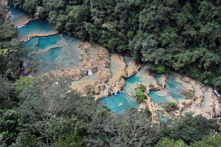 Landscapes of stepped pools of water, all turquoise in color in the CahabÃ³n River, as it passes through the Semuc Champey Park, in the jungle of central Guatemalaの写真素材