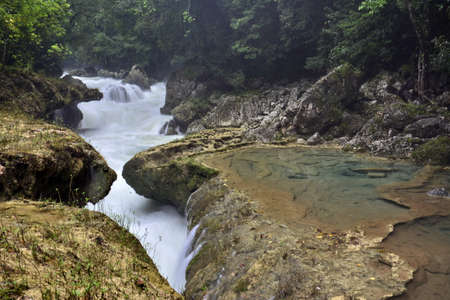 Landscapes of stepped pools of water, all turquoise in color in the CahabÃ³n River, as it passes through the Semuc Champey Park, in the jungle of central Guatemalaの写真素材
