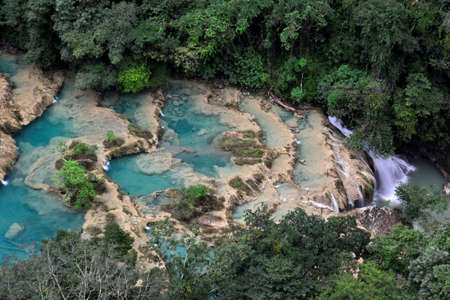 Landscapes of stepped pools of water, all turquoise in color in the CahabÃ³n River, as it passes through the Semuc Champey Park, in the jungle of central Guatemalaの写真素材