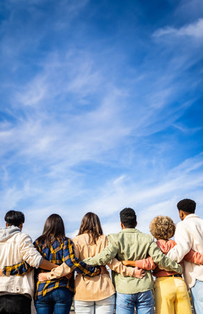 United group of young friends hugging each other standing in a rowの写真素材