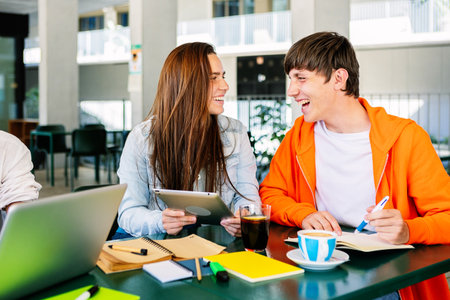 Diverse students learning together in the cafeteria of the college campus