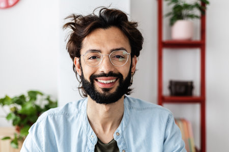 Successful young entrepreneur smiling at camera on video call