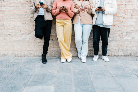 Group of young teen people using smart phone outdoor