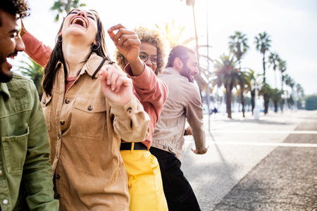 Funny group of multiracial friends dancing twerking in the street