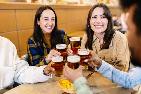 Group of happy young friends enjoying drinks at brewery pub barの写真素材