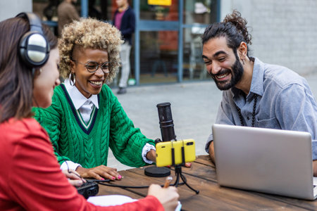 Diverse adult blogger students recording podcast in bar terraceの写真素材
