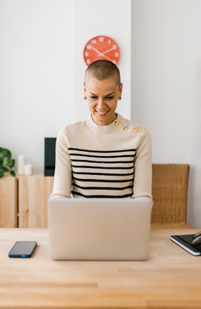 Mid adult woman working on laptop computer in the office
